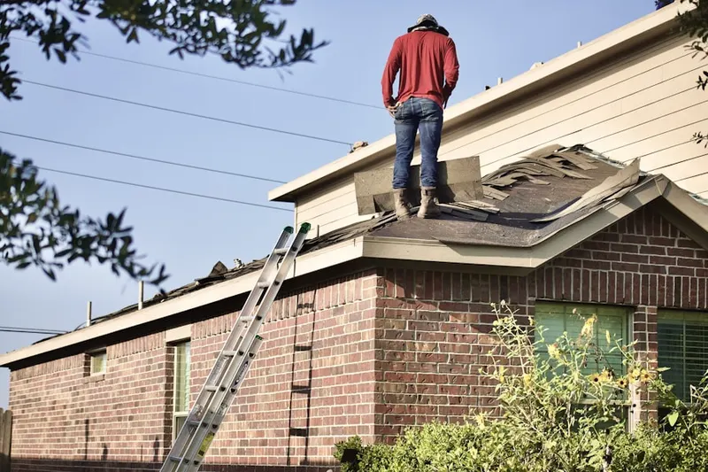 Professional roofer working on a residential roof in Old Jamestown